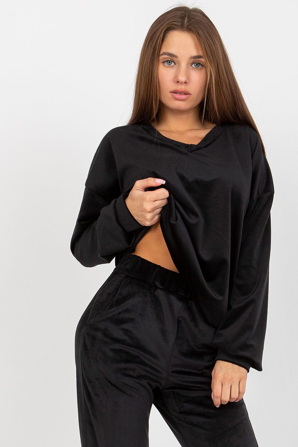 Chic close-up of a women's black velour sweatshirt with a heart neckline, accentuating its soft fabric and contemporary design.