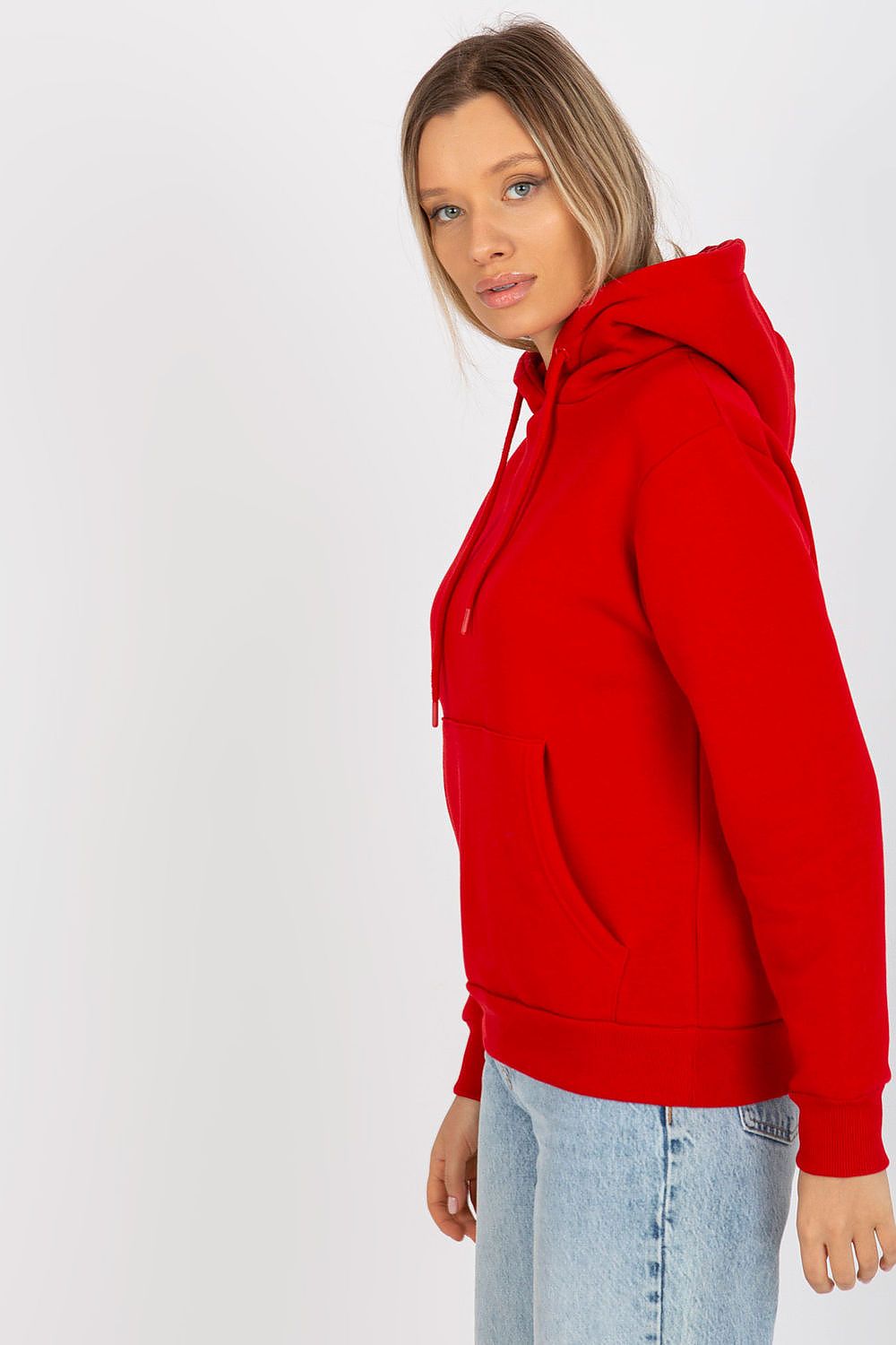 Sophisticated side profile of a woman in a red hooded sweatshirt by Rue Paris, blending comfort and contemporary style.