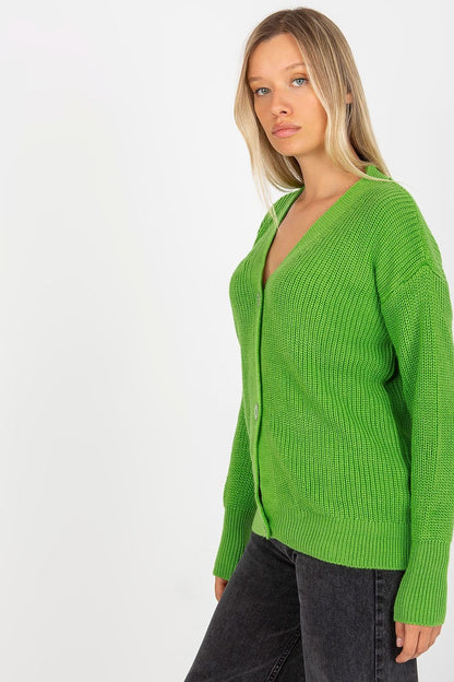 Elegant green acrylic cardigan from Rue Paris, featuring button closure and long sleeves, styled with a chic and sophisticated look.
