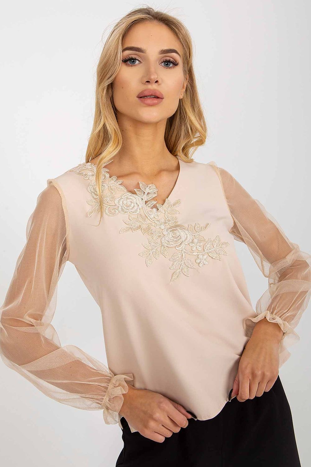 Close-up of the Lakerta blouse showcasing detailed floral embroidery on the heart neckline and sheer mesh sleeves, exemplifying luxurious style.