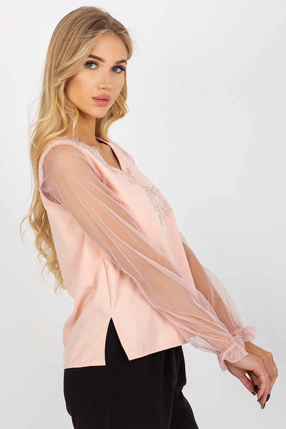 Fashion-forward pink blouse with romantic long mesh sleeves and floral embroidery, showcasing a refined heart neckline for a luxurious touch.