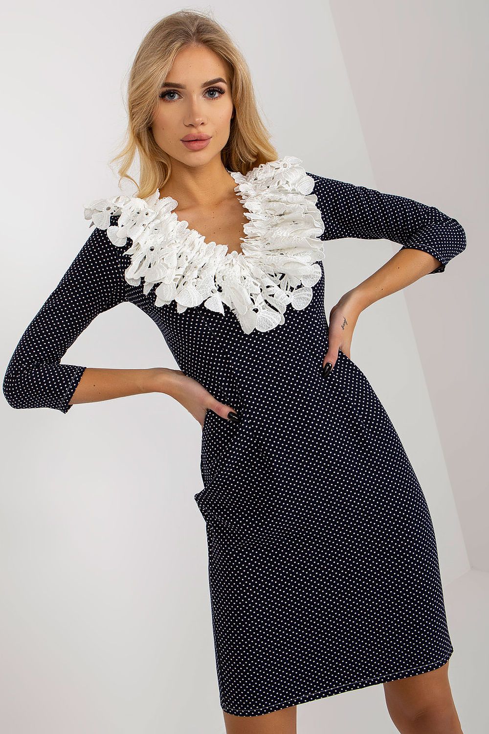 Elegant Lakerta pencil cut cocktail dress featuring 3/4 sleeves and intricate lace detailing, styled in a polka dot pattern, showcasing a chic neckline.