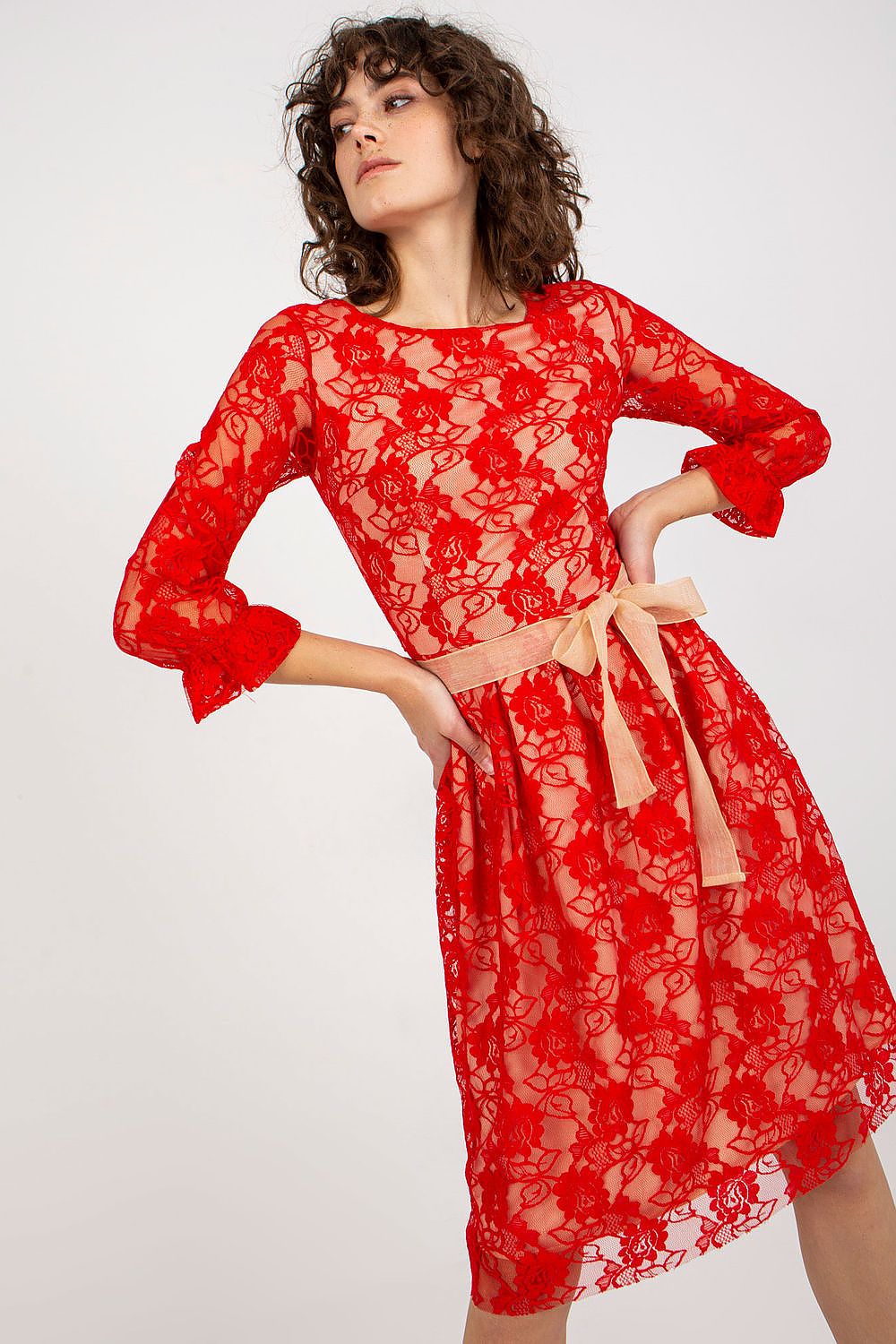 Elegant red lace evening dress by Lakerta featuring 3/4 sleeves and a waist sash, showcased in a luxurious setting.