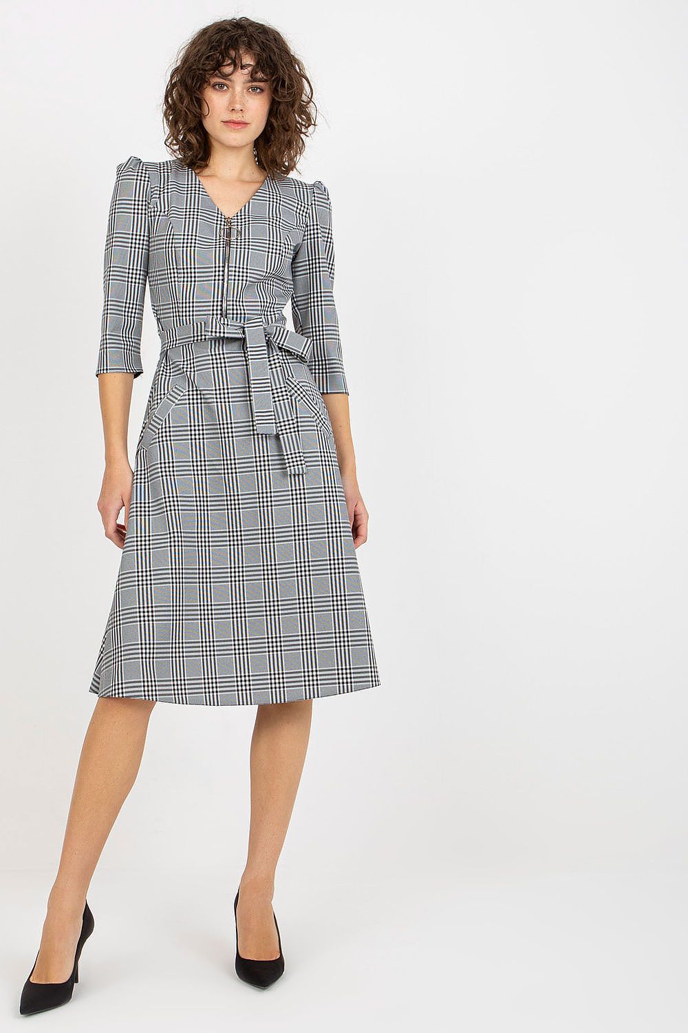 Elegant checkered daydress featuring a zip closure and a waist tie, designed for a sophisticated look. The dress is complemented by 3/4 sleeves and stylish slip pockets, perfect for any occasion.