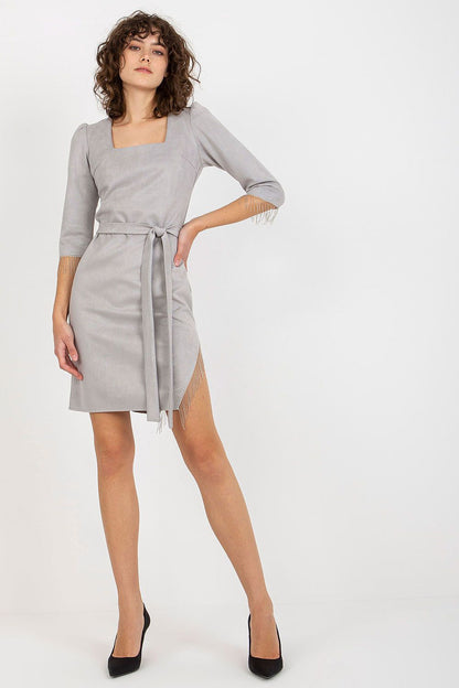 Chic Lakerta evening dress in luxurious grey, showcasing a square neckline, 3/4 sleeves with elegant tassels, and a flattering tie belt, ideal for upscale events.