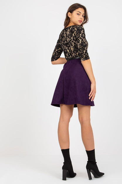 Sophisticated back view of a woman in a stunning black lace evening dress with a purple skirt and sleek ankle boots, radiating elegance and modern style.
