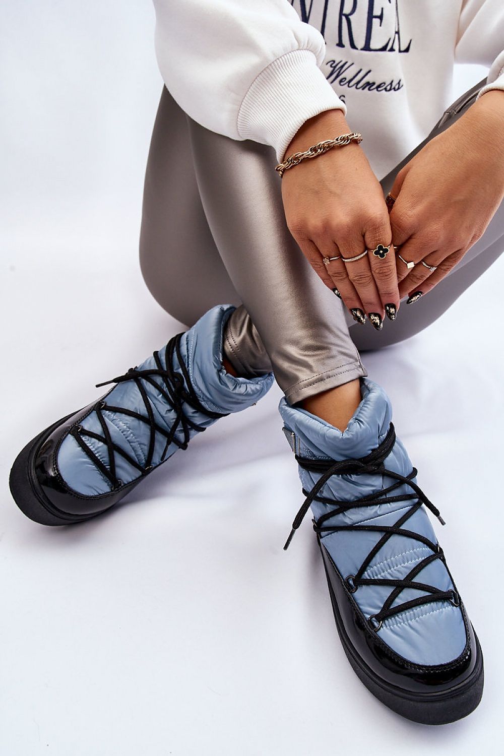 Luxurious women's snow boots featuring eco leather, fur insulation, and a stylish slip-on design, showcased on a model wearing metallic leggings.