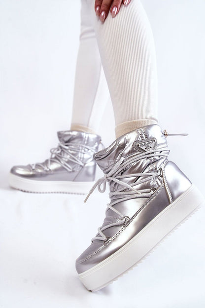 Side view of stylish silver women's snow boots featuring fur insulation, high platform sole, and decorative lacing, perfect for winter fashion.