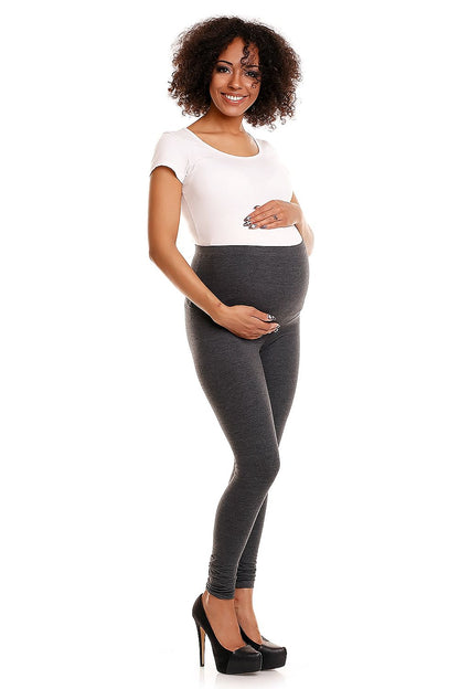 Luxury maternity leggings by PeeKaBoo showcased on a model, featuring a comfortable, pressureless knit with tummy support, styled with a fitted white top and high heels, presenting a chic look for expecting mothers.