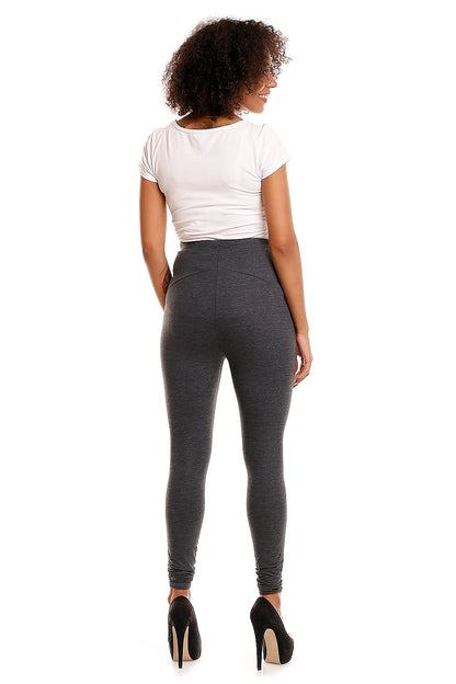 Rear view of luxury maternity leggings by PeeKaBoo on a model, highlighting the sleek design and tummy support, paired with a fitted white top and elegant high heels, perfect for stylish pregnant women.