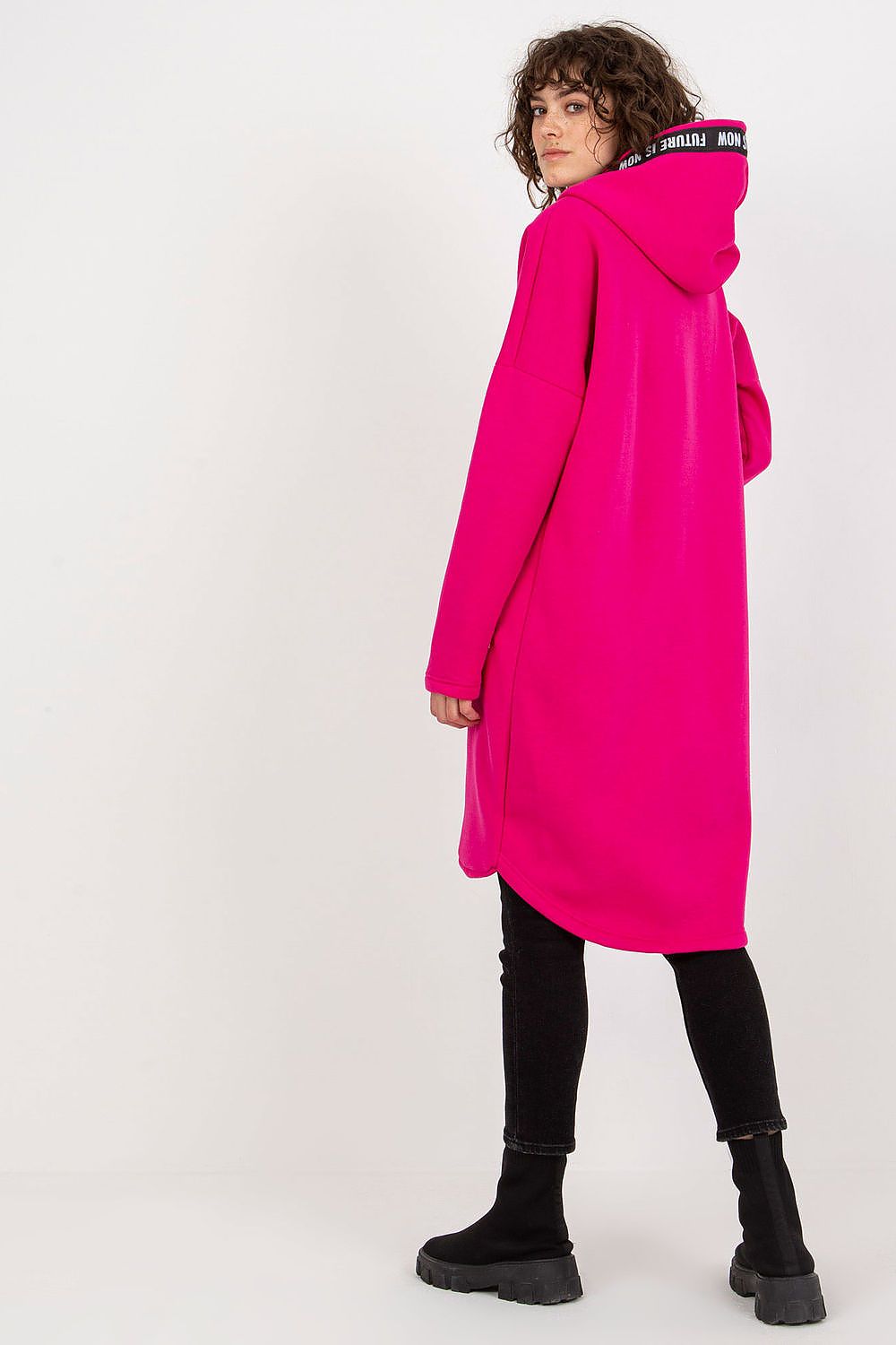 Luxury women's zippered hooded sweatshirt in vibrant pink, featuring an extended cut and stylish design, showcased on a model from the back.