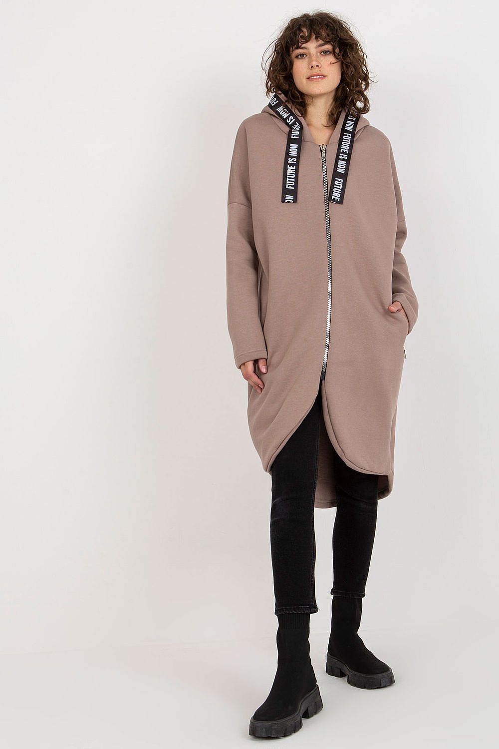 Stylish luxury women's hooded sweatshirt in taupe, designed with an extended cut and zip pockets, elegantly worn by a model in a casual pose.