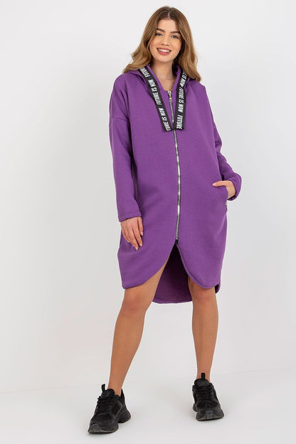 Stylish women's purple hooded sweatshirt with a front zipper and luxurious extended cut, complemented by casual yet fashionable footwear for an effortlessly trendy outfit.