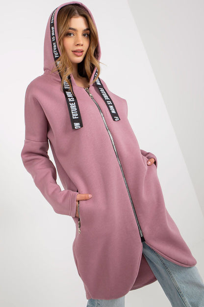 Luxury women's zippered hooded sweatshirt in soft pink with extended cut, featuring stylish logo drawstrings and zippered pockets, perfect for casual chic outfits.
