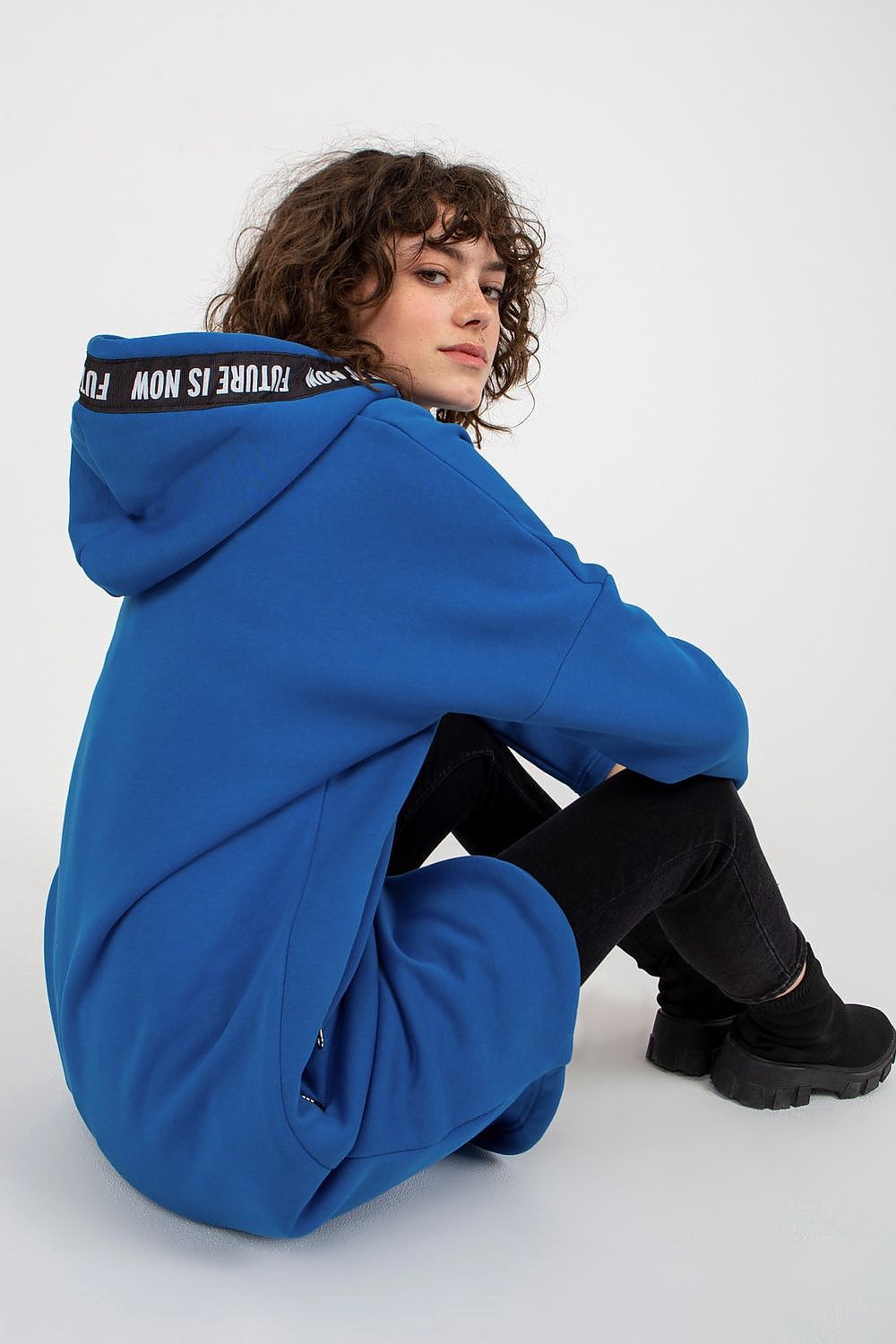 Luxurious women's oversized hooded sweatshirt in vibrant blue, showcasing extended cut and stylish design, perfect for modern fashion.