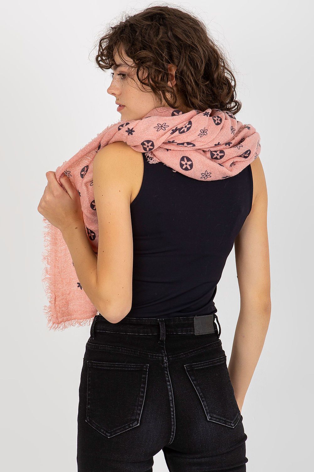 Trendy model showcasing the luxurious neckerchief as she casually wraps it around her shoulders, highlighting its stylish design and fabric texture.