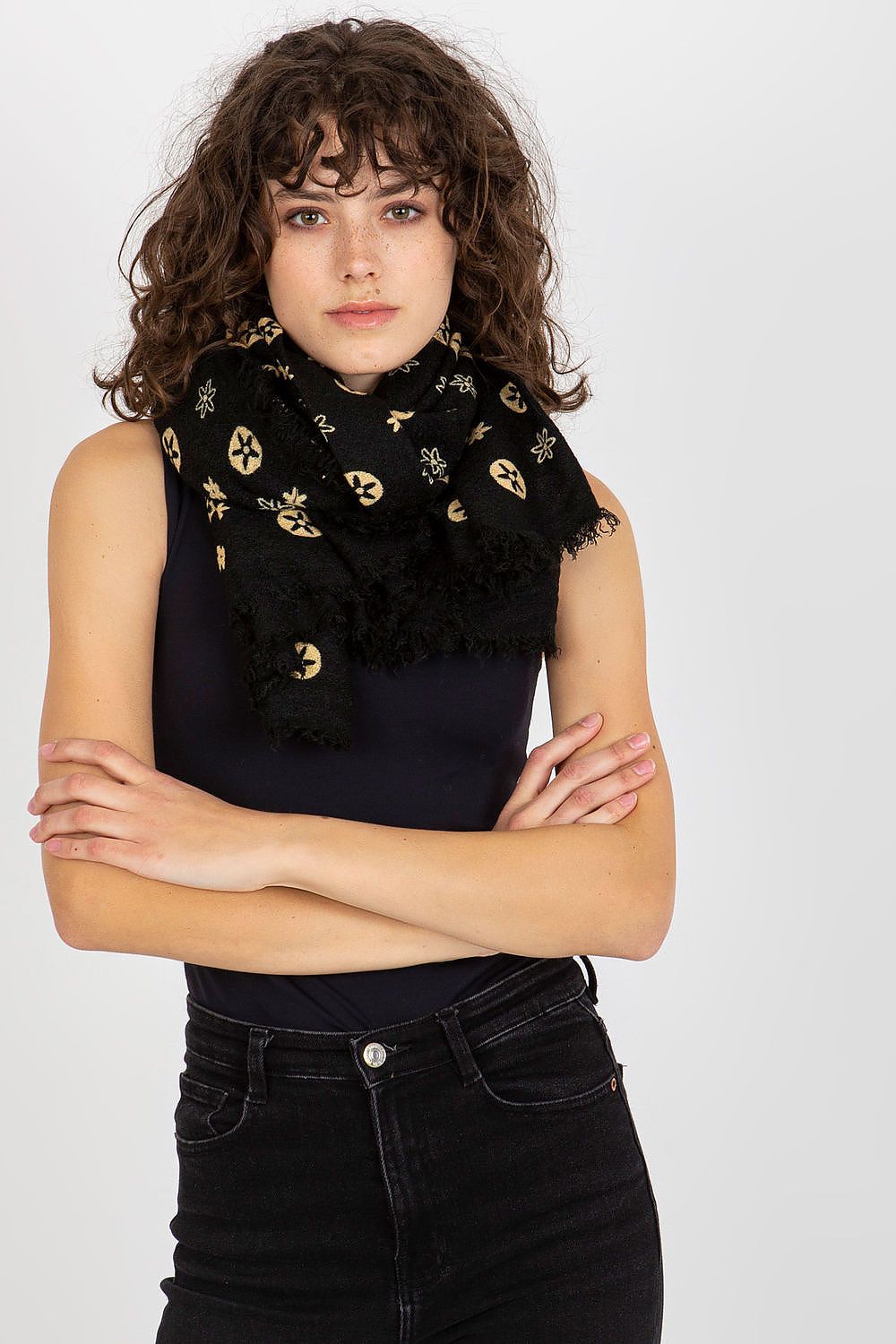 Close-up of a sophisticated woman wearing a luxury black neckerchief. The scarf features unique patterns with golden accents, elegantly styled around her neck, enhancing her fashionable look.