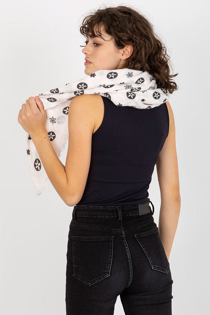 Back view of a model elegantly wearing a luxurious floral neckerchief, highlighting its softness and stylish design.