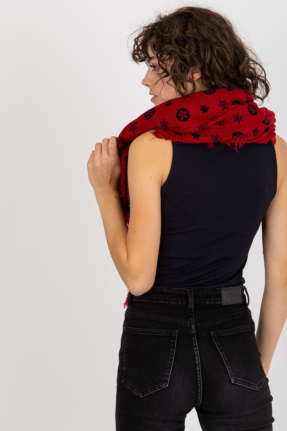 Stylish red neckerchief wrapped elegantly over shoulders against a neutral background, highlighting the intricate pattern design.