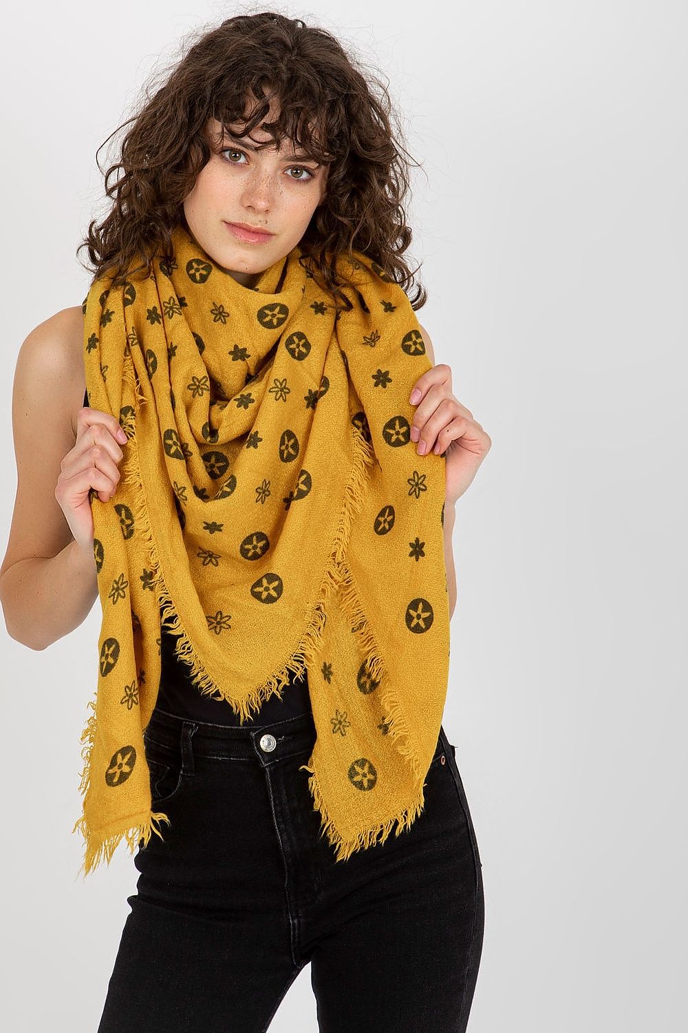 Luxurious mustard yellow neckerchief draped gracefully in front, showcasing its floral and geometric pattern.