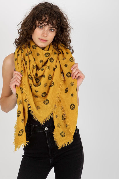Luxurious mustard yellow neckerchief draped gracefully in front, showcasing its floral and geometric pattern.