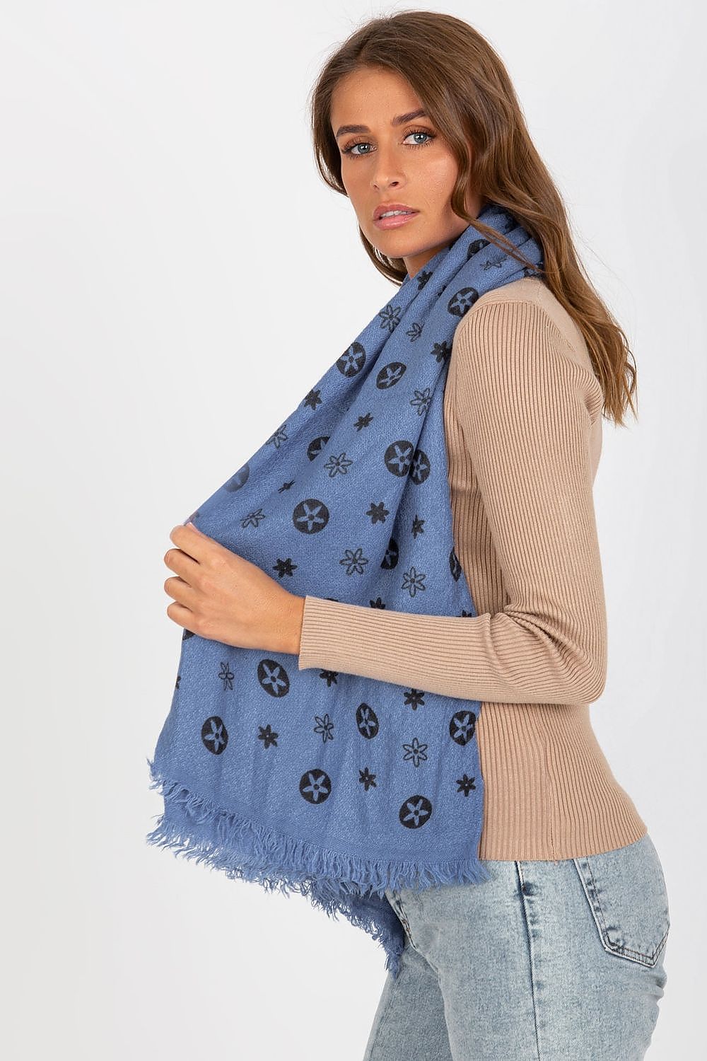 An elegant woman gracefully draping a luxury 100% acrylic neckerchief adorned with a stylish pattern, showcasing its rich blue hue against a chic beige outfit.