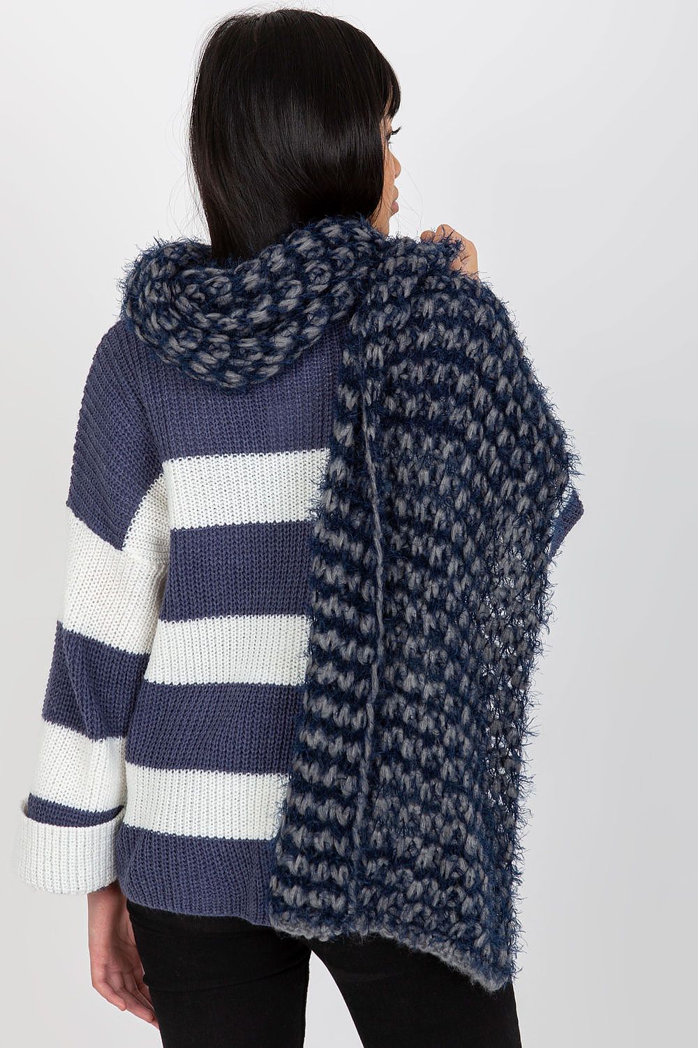 Chic rear view of a model showcasing the voluminous knitted acrylic scarf in navy tones with a stylish knitted sweater.