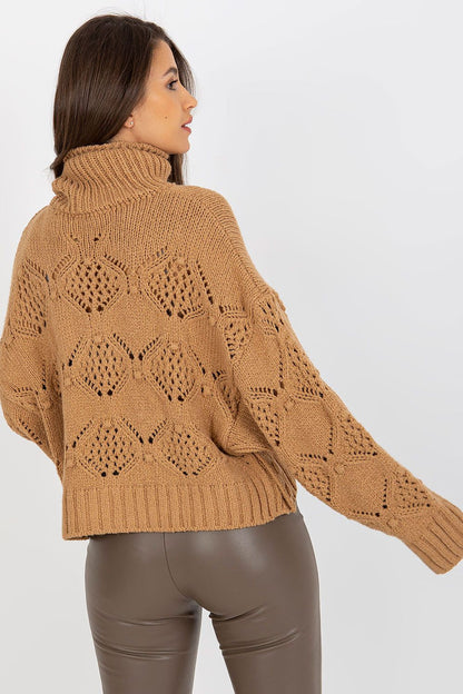Back view of a luxury openwork turtleneck sweater, showcasing intricate knit detailing and relaxed fit, paired elegantly with leather pants for a chic ensemble.