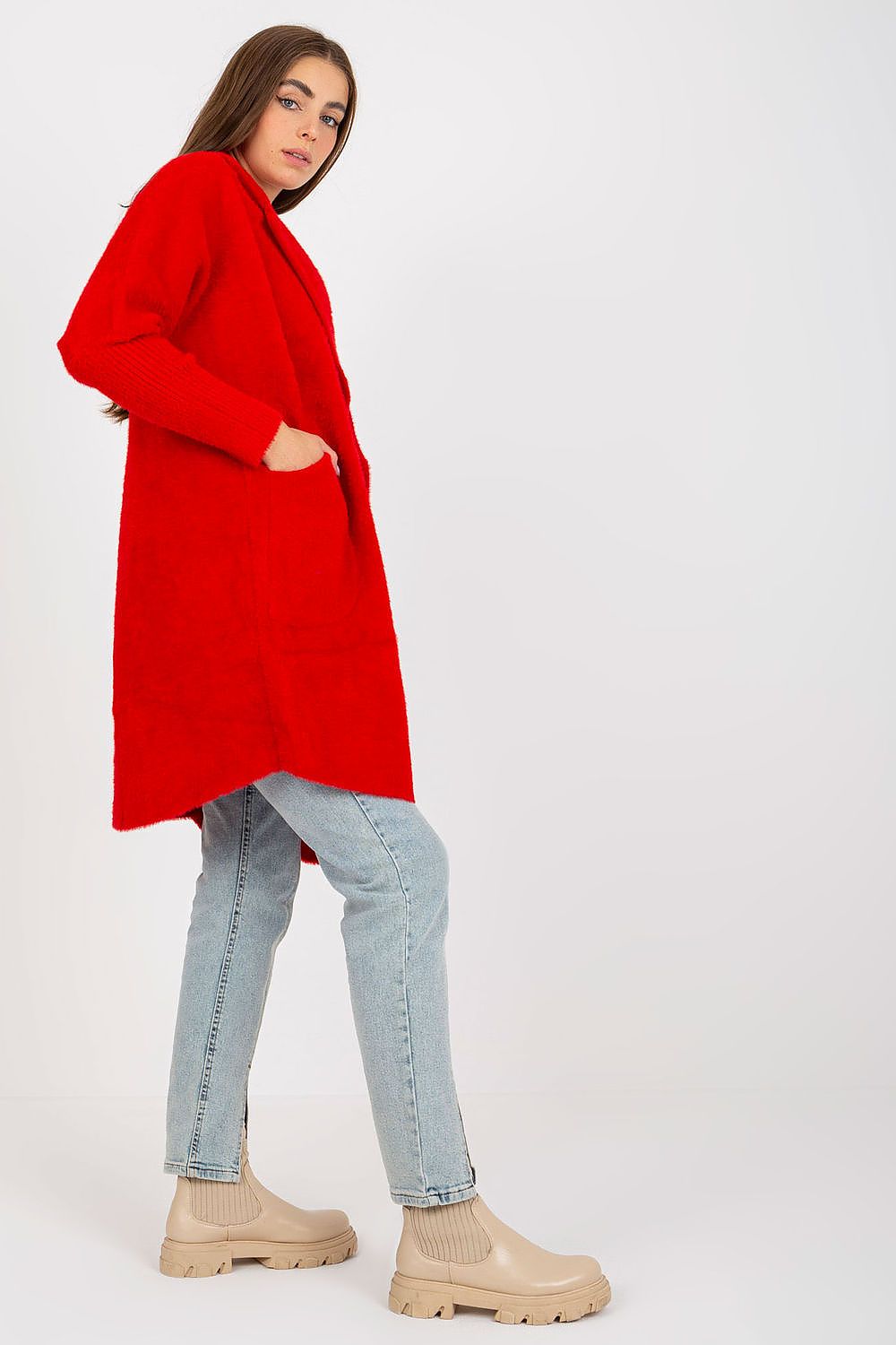 Chic side view of Women's MBM Angora Wool Blend Coat in striking red, showcasing its long sleeves and convenient slip pockets, complemented by light blue denim and trendy ankle booties.