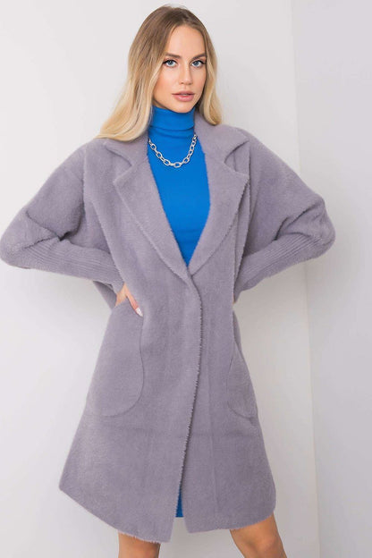 Refined Women's MBM Angora Wool Blend Coat in soft grey, elegantly styled over a blue turtleneck, featuring long sleeves and spacious pockets, exuding a luxurious aesthetic.