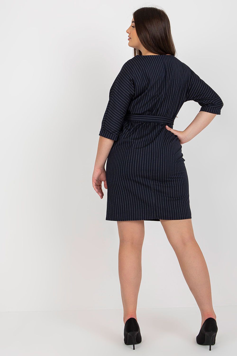 Back view of a luxury plus size pencil dress by Lakerta, showcasing its flattering fit and elegant design with a tie belt.