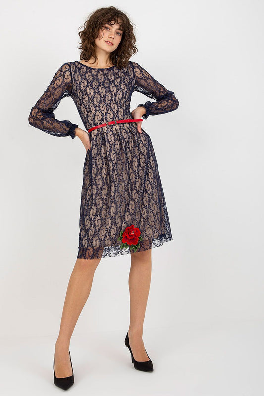 Elegant lace evening dress with long sleeves, featuring floral embellishments and a red belt, showcased against a clean backdrop.