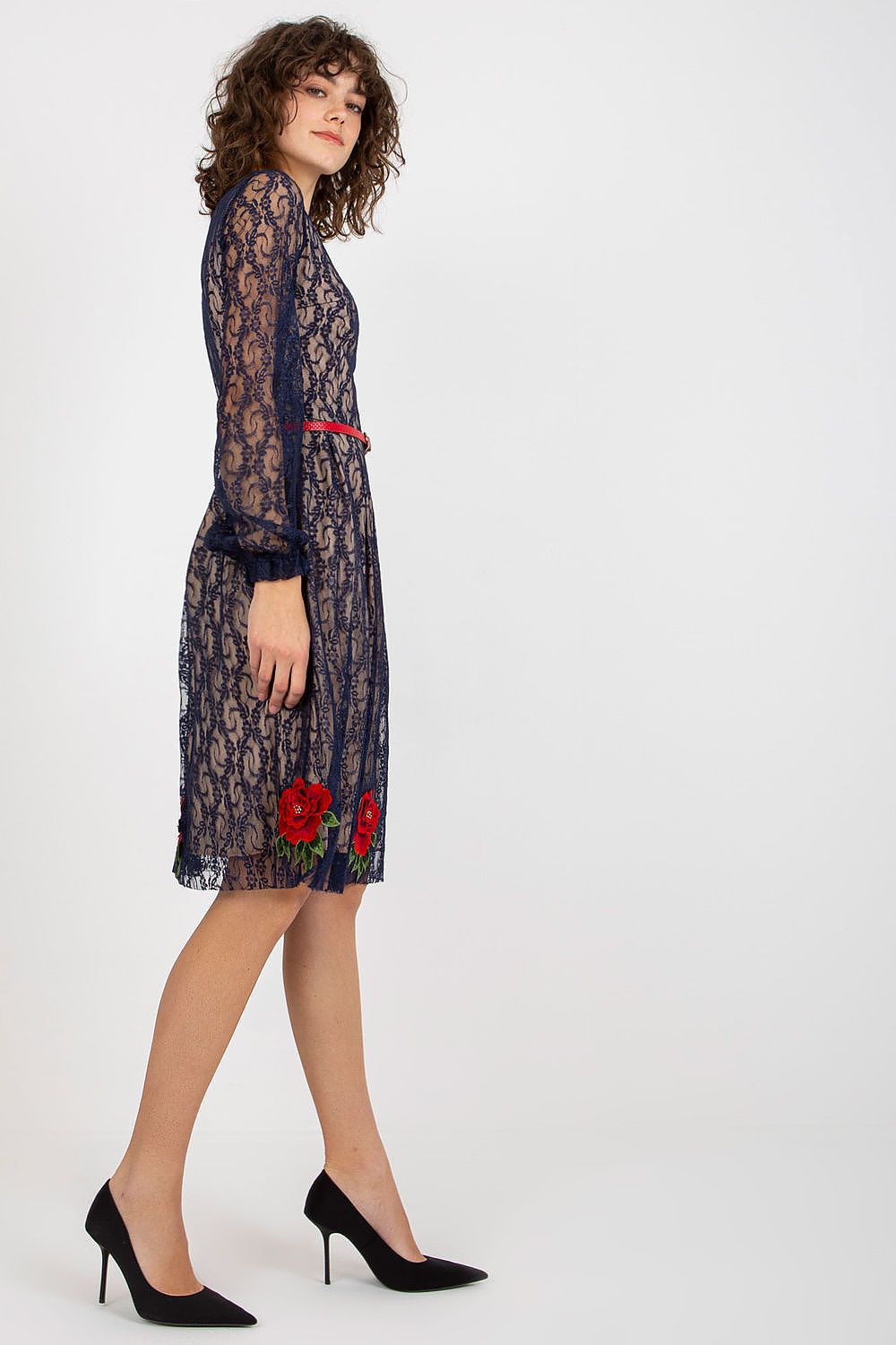 Side view of a luxurious lace evening dress with long sleeves and floral details, accented by a striking red belt.
