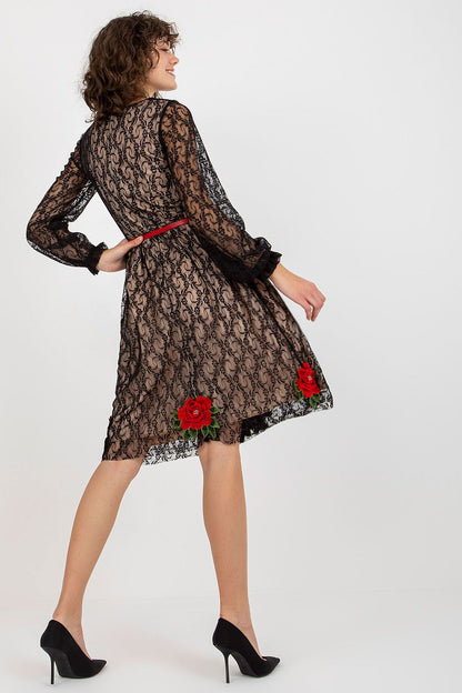 Back view of a sophisticated lace evening dress, showcasing floral accents and a flattering silhouette, enhanced by a red belt.