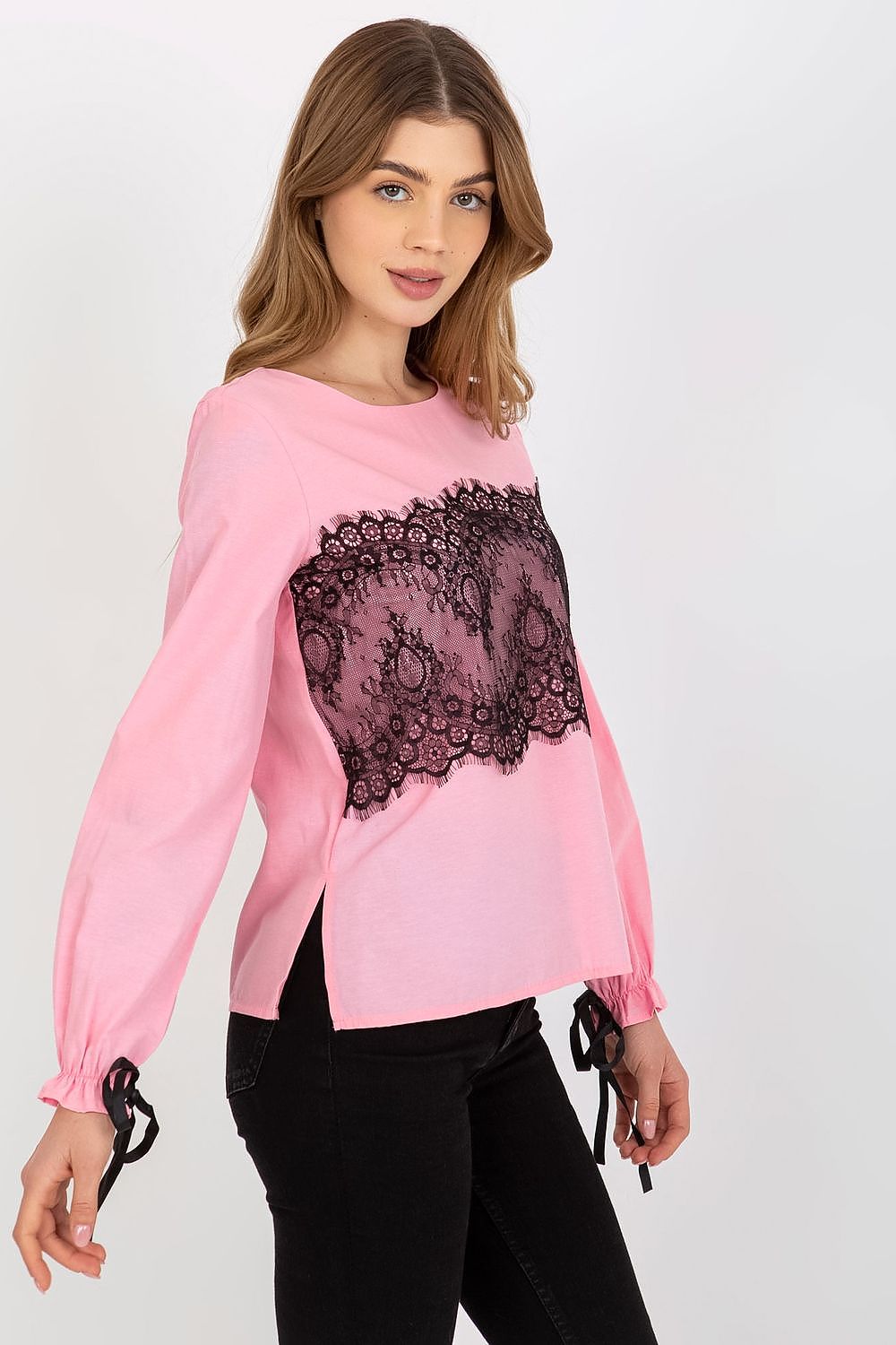 Chic pink cotton blouse featuring long sleeves and decorative black lace, styled for a fashionable look.