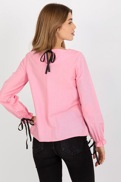 Back view of a stylish pink luxury cotton blouse showcasing long sleeves and black lace detail, ideal for elevated casual wear.