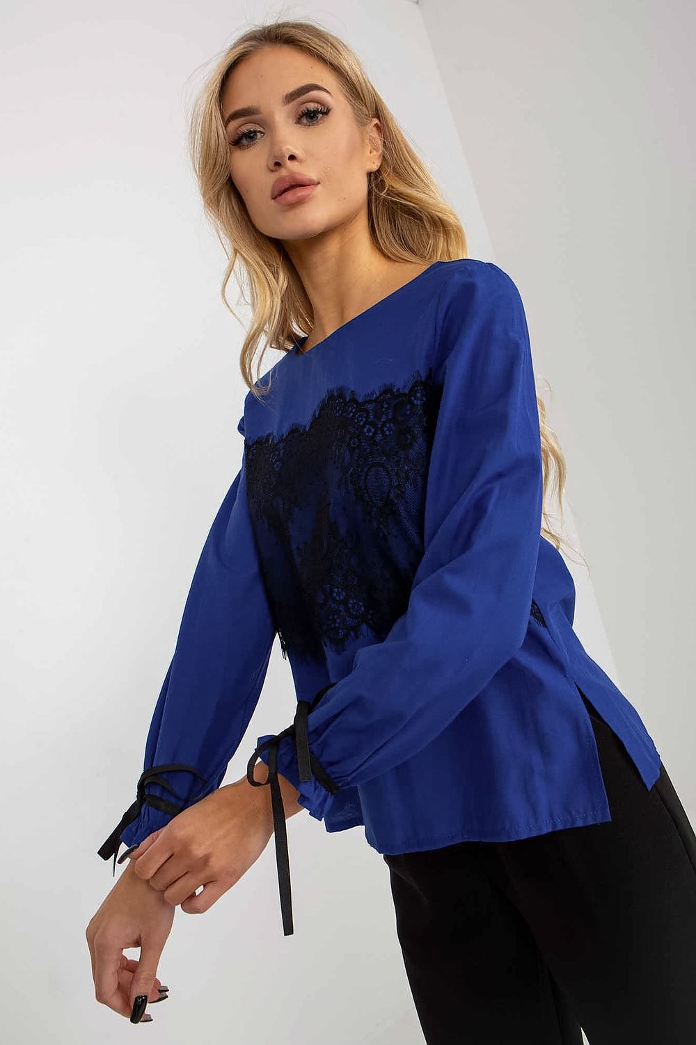 Side view of a stunning blue cotton blouse featuring elegant black lace and long sleeves, designed for a refined appearance.