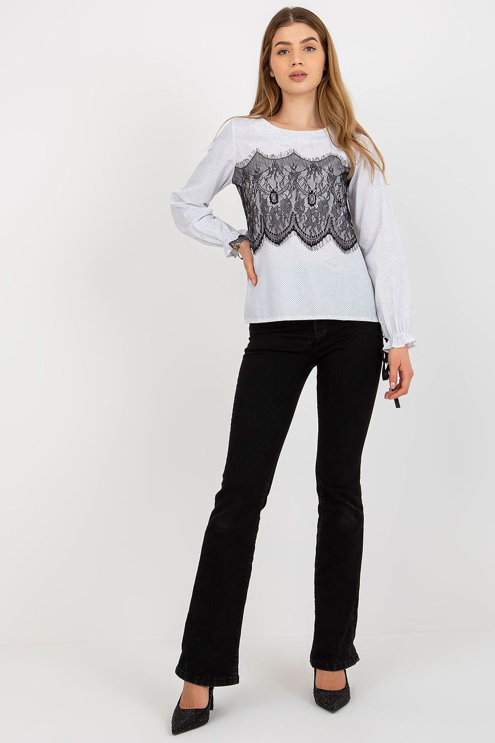 Trendy white blouse with black lace detailing, paired with stylish black jeans, showcasing the modern elegance of Lakerta.