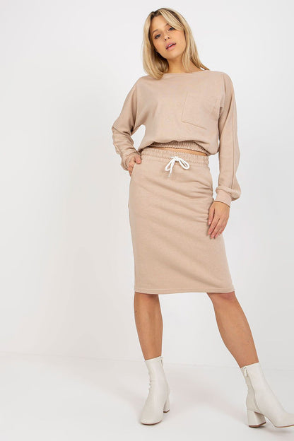Elegant Ex Moda tracksuit set in soft beige, highlighting a classic long sleeve sweatshirt and a coordinating high-waisted skirt with an elastic waist and drawstring detail.