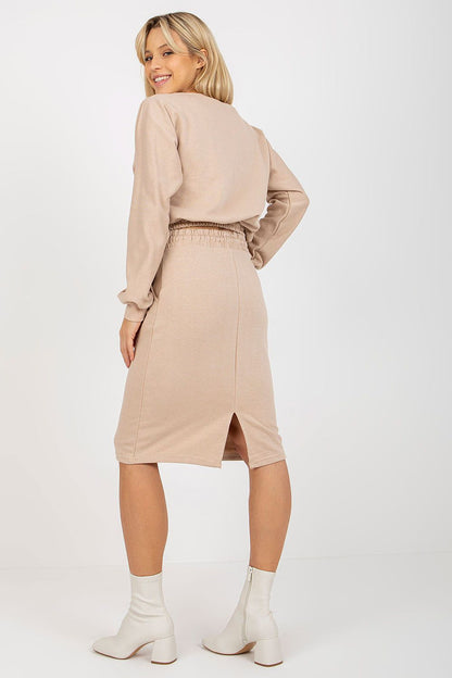 Back view of a sophisticated beige Ex Moda tracksuit set, emphasizing the stylish long sleeve sweatshirt and skirt with a chic slit and subtle detailing.