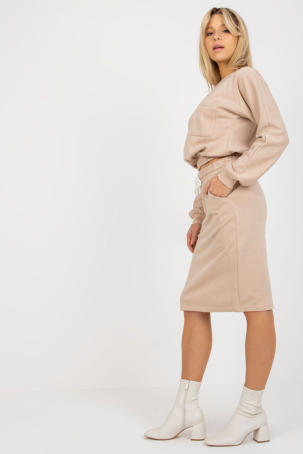 Luxury Ex Moda tracksuit set featuring a long sleeve cotton blend sweatshirt paired with a stylish waist tie skirt, elegantly styled against a minimalist backdrop. The outfit exemplifies contemporary fashion with a focus on comfort and sophistication.