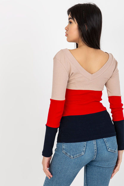 Back view of a refined model in a luxury ribbed blouse displaying a flattering heart neckline, highlighting the exquisite colour blocking of beige, red, and navy, ideal for versatile fashion.