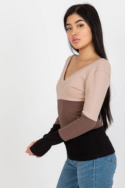 Side profile of a stylish model wearing a luxury ribbed blouse featuring a heart neckline, showcasing a chic colour block of beige, brown, and black, perfect for fashion-forward looks.