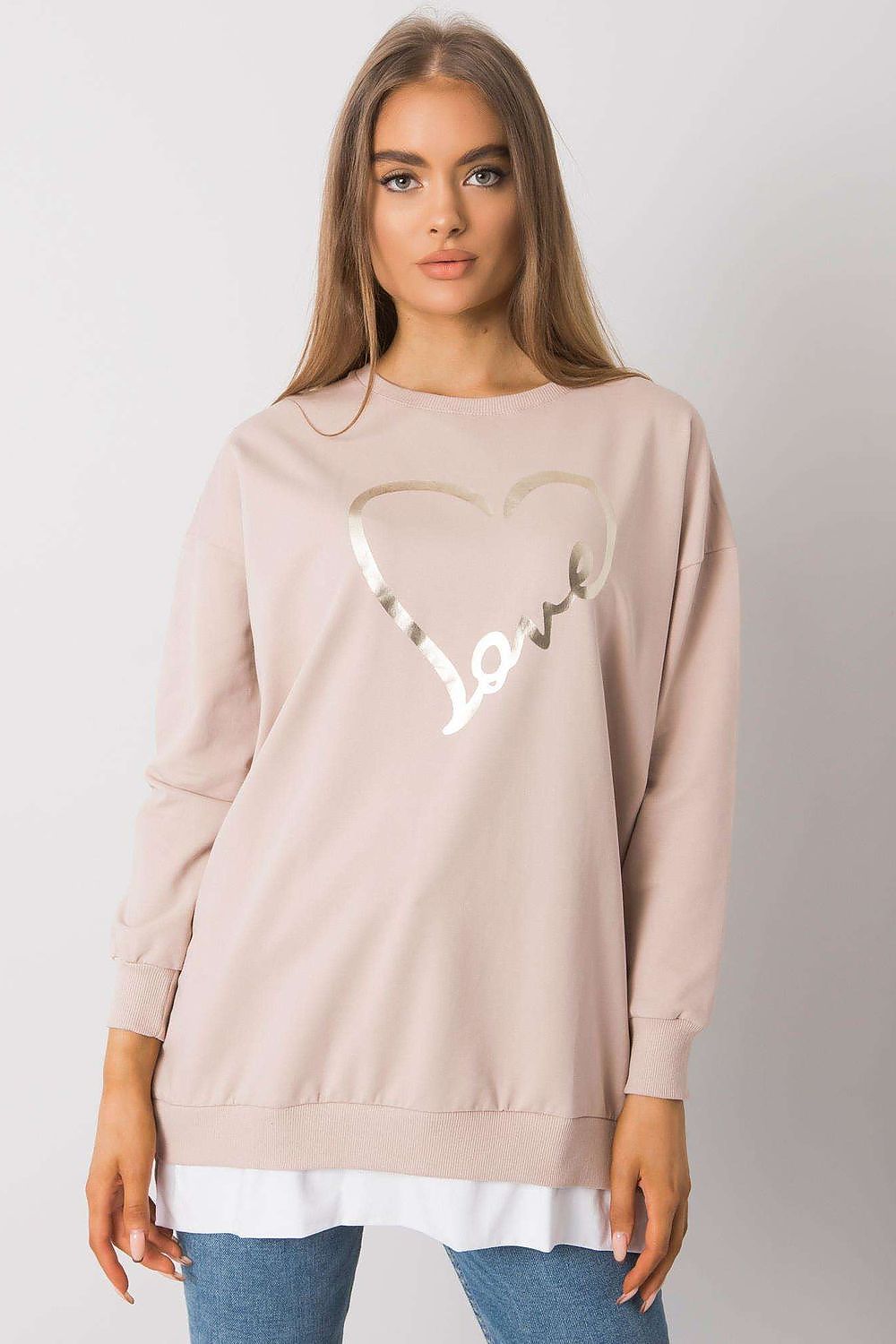 Sophisticated view of a Rue Paris loose-fitting tunic showcasing a metallic heart design, elegantly paired with jeans, ideal for chic everyday fashion.