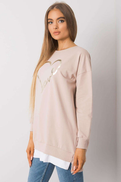 Elegant long-sleeve tunic featuring a decorative 'love' print, styled with casual denim, highlighting a chic and luxurious aesthetic.