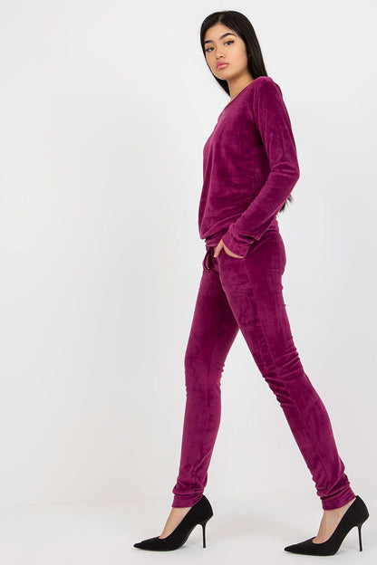 Graceful model in a purple velour ensemble showcasing the stylish details, including a glow of luxury and sophistication, perfect for both casual and dressy occasions.