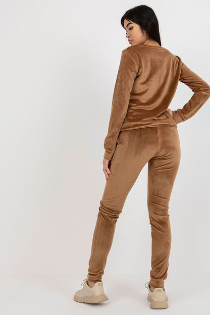 Back view of a fashionable velour blouse and pants set by Rue Paris, highlighting the contemporary style and luxe fabric in a sophisticated brown shade.