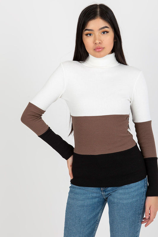 Luxurious ribbed turtleneck sweater in a sophisticated colour block design, featuring elegant white, brown, and black sections, modelled by a fashionable woman. Perfect for chic winter outfits.