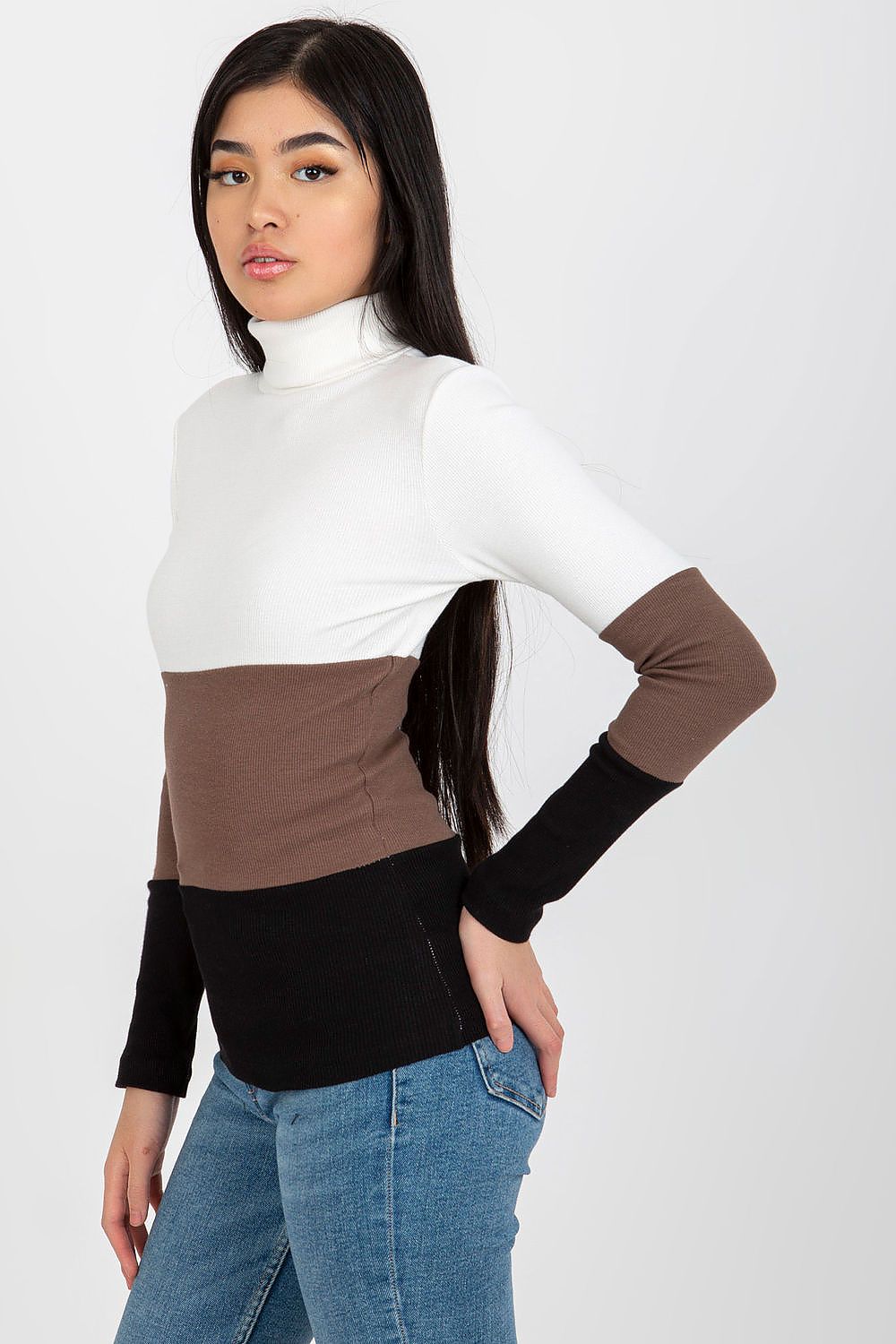 Stylish ribbed turtleneck sweater showcasing a refined colour block pattern with white, brown, and black hues, elegantly displayed by a model. Ideal for sophisticated layering.