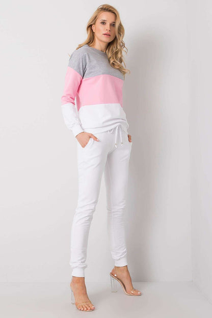 Side view of a model in a luxury 2-piece cotton sweatshirt and jogger set by Rue Paris, showcasing the elegant grey, pink, and white colour combination.